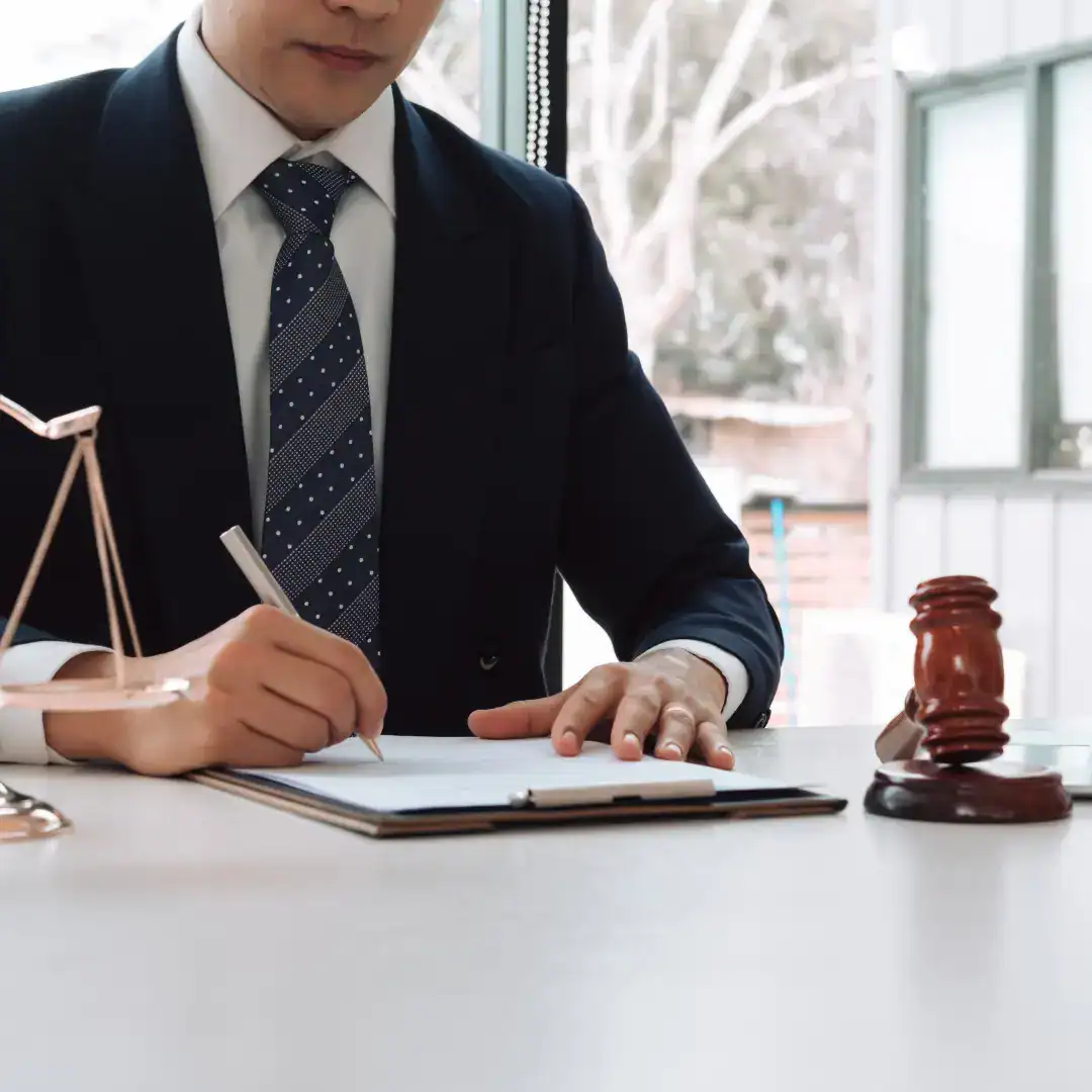 Tax attorney reviewing IRS documents at a desk with a gavel and scales