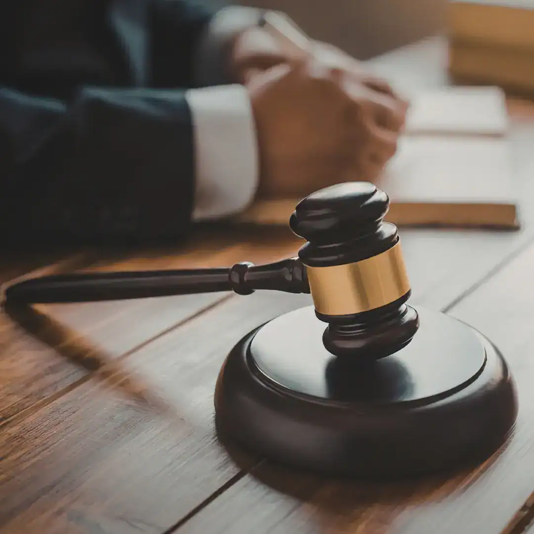 Gavel on a desk beside an attorney reviewing case documents